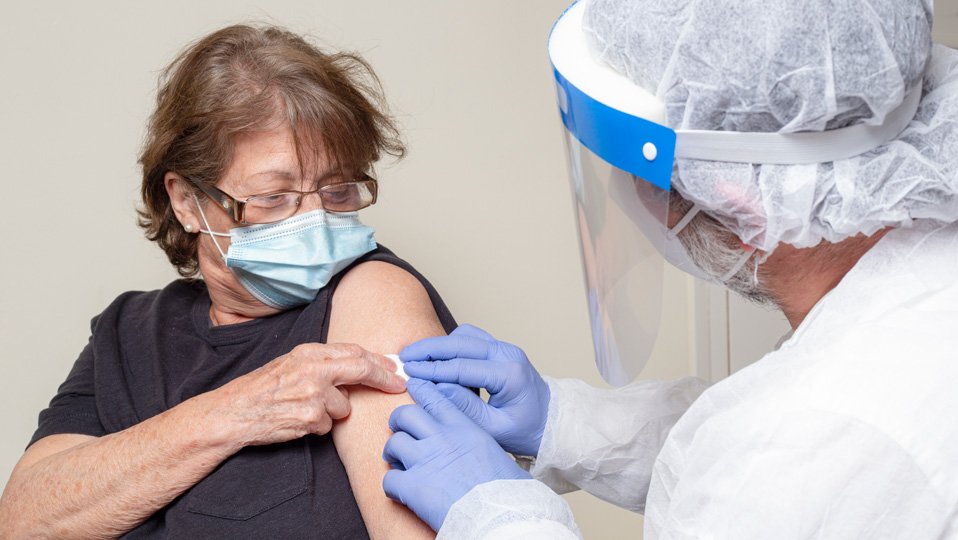 Woman having an injection in her arm